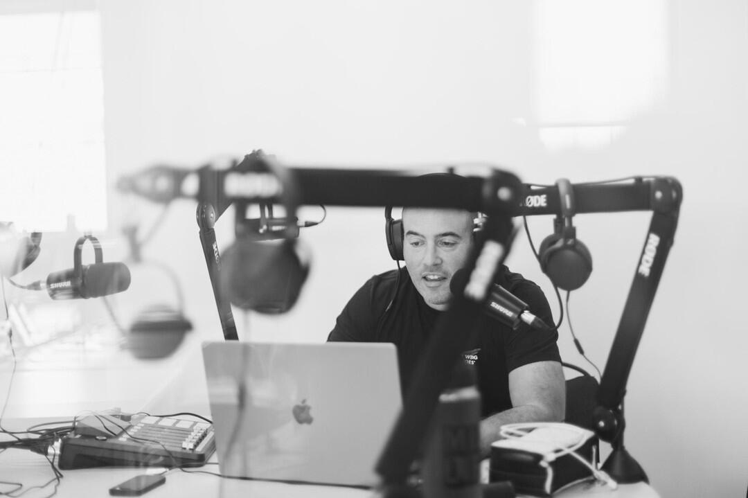 Alex sitting in a podcast studio
